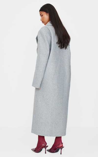 Double breasted grey coat featuring full length and structured shoulders in USA
