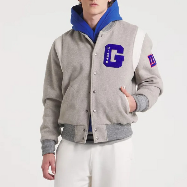 Person wearing a gray varsity jacket with blue hood and 'GIANTS' logo on a white background in USA